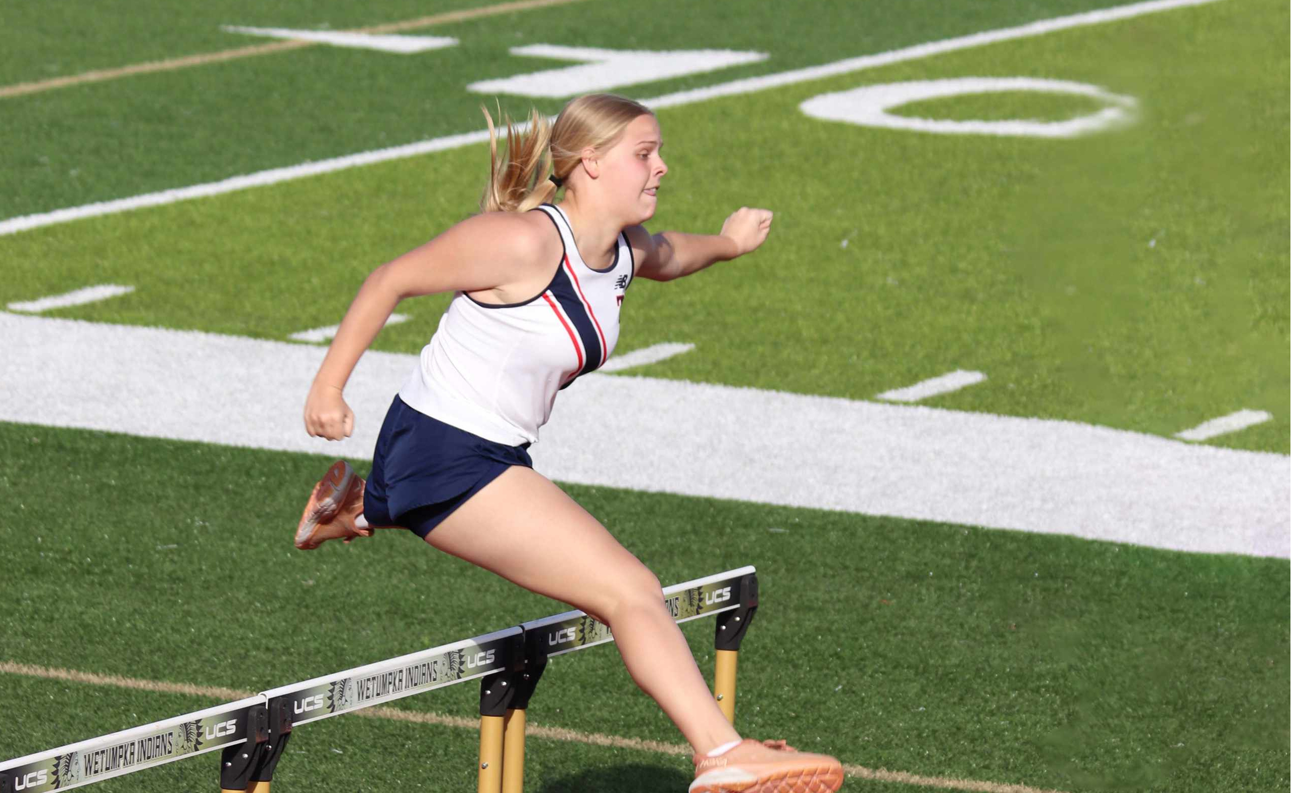Student athlete clearing hurdle